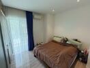 Bedroom with brown bedding and ample natural light