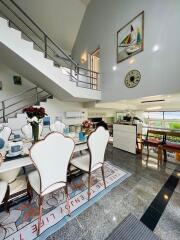 Spacious dining area with modern furniture and elegant decor in a multi-level home