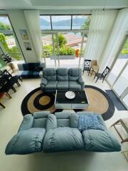 Spacious living room with modern furniture and large windows offering a scenic view