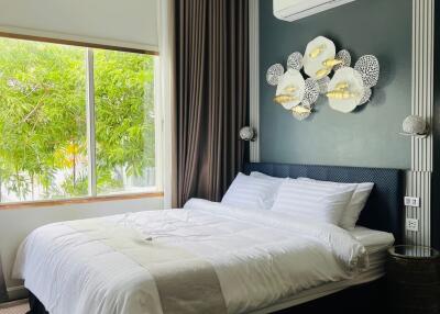 Modern bedroom with wall-mounted AC unit and window view