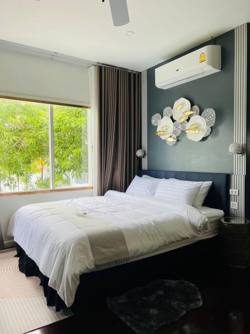 Modern bedroom with wall-mounted AC unit and window view