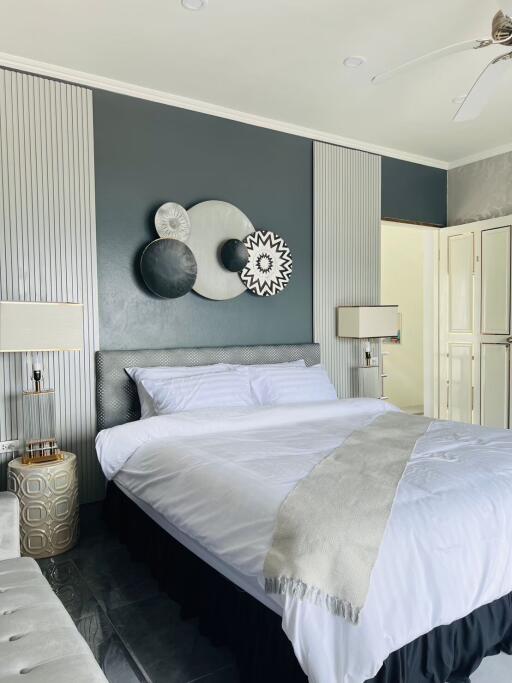 Modern bedroom with decorative wall art and white bedding