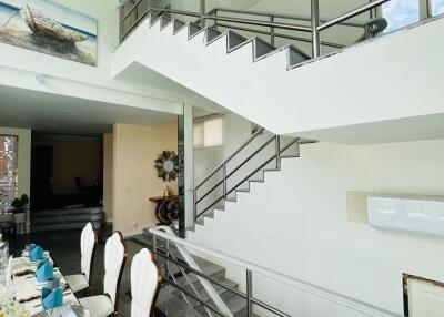 Modern main living area with staircase and dining table
