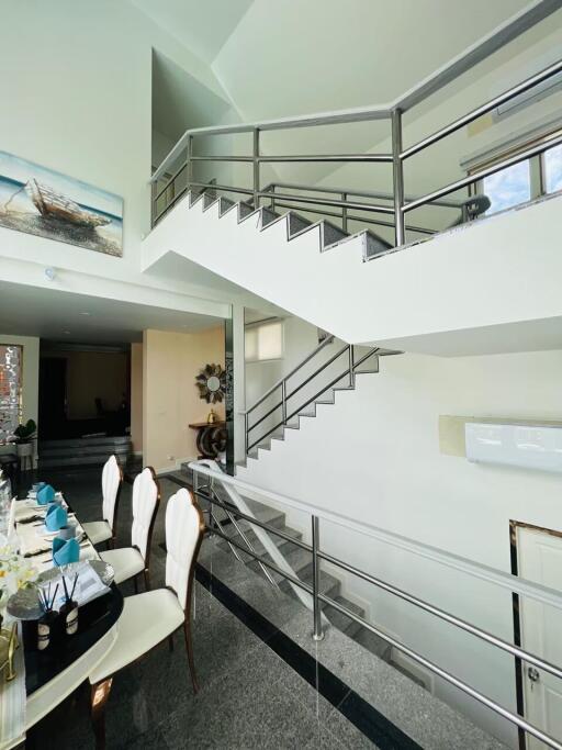 Modern main living area with staircase and dining table