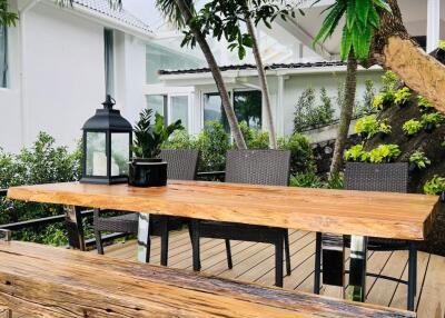 Outdoor dining area with wooden table and bench