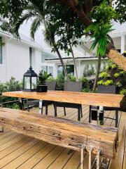 Outdoor dining area with wooden table and bench