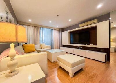 Modern living room with beige couches and hardwood floor