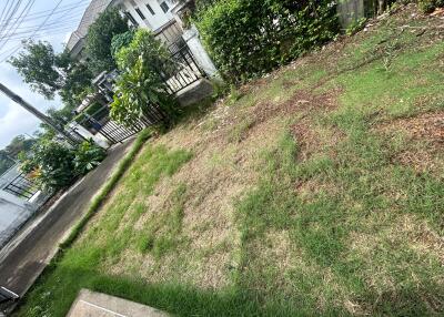 Image of the garden area of the property with a view of the front gate and neighboring houses.