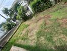 Image of the garden area of the property with a view of the front gate and neighboring houses.