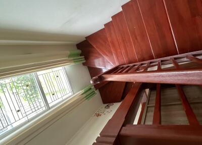 Wooden staircase with railing and window