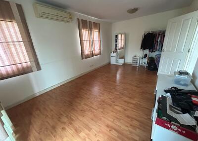 Spacious bedroom with wooden flooring