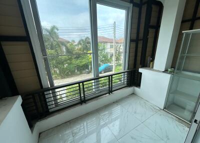 Spacious balcony with large windows overlooking neighborhood