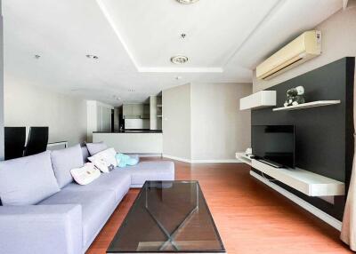 Modern living room with sofa, TV, and air conditioning