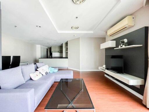 Modern living room with sofa, TV, and air conditioning