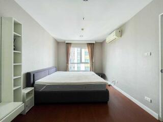 Spacious bedroom with a large bed and natural light