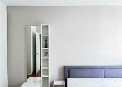 Modern minimalist bedroom with shelf and mirror
