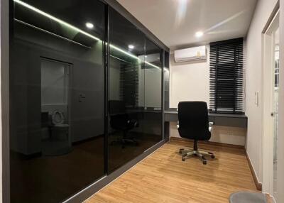 Modern home office with black sliding door closets