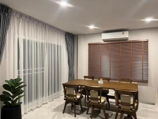 Contemporary dining room with wooden table, chairs, and modern lighting