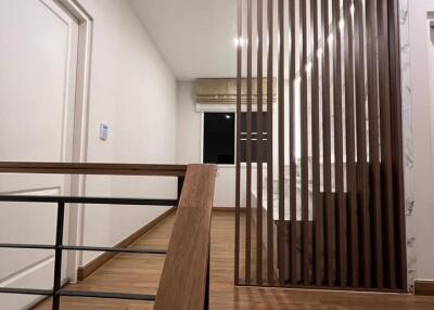 Modern hallway with wooden flooring and railing