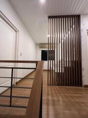 Modern hallway with wooden flooring and railing