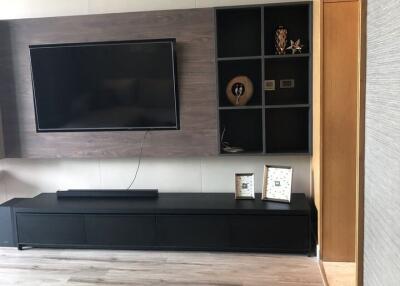 Modern living room with flat-screen TV and stylish shelving