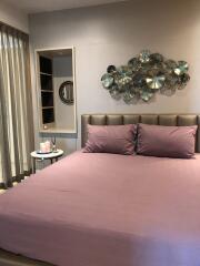 Modern bedroom with decorative wall art and bedside table