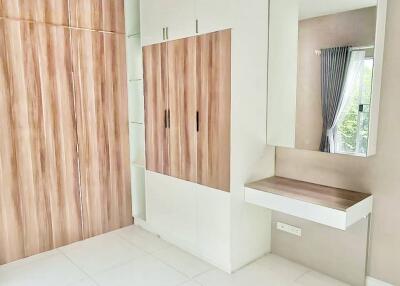 Modern bedroom with built-in wardrobe and vanity area