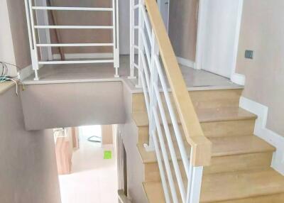 Modern staircase with wooden steps and white railing