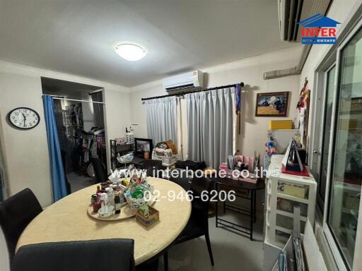 Dining area with a table, chairs, air conditioner, and decorative items