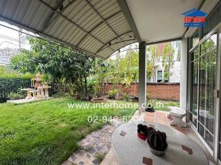 Covered outdoor patio with a garden view