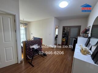 Living room with wooden flooring and exercise equipment