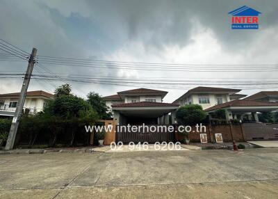 Exterior view of residential buildings with contact information for Interhome Real Estate