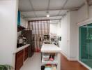 Modern kitchen with island, stainless steel appliances, and wooden accent wall