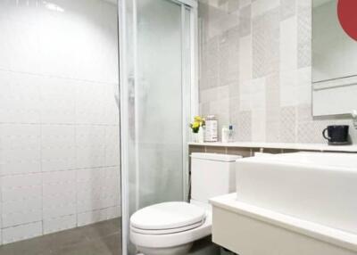 Modern bathroom with glass shower door and white fixtures