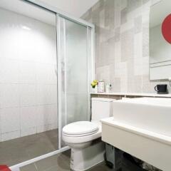 Modern bathroom with glass shower door and white fixtures