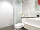 Modern bathroom with glass shower door and white fixtures