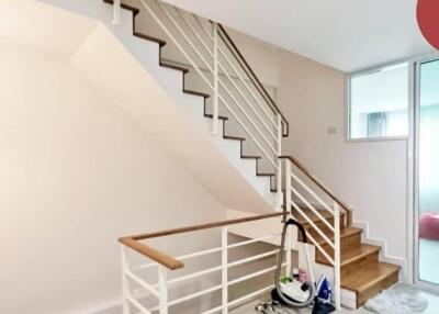 Staircase area with modern railing and cleaning equipment