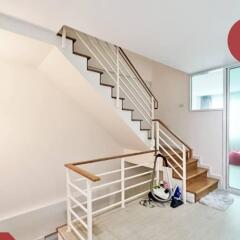 Staircase area with modern railing and cleaning equipment