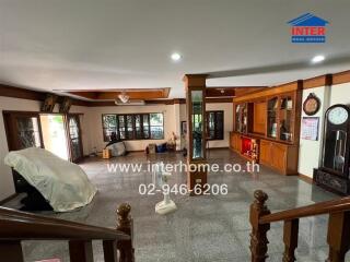 Spacious living room with wooden accents and various furniture