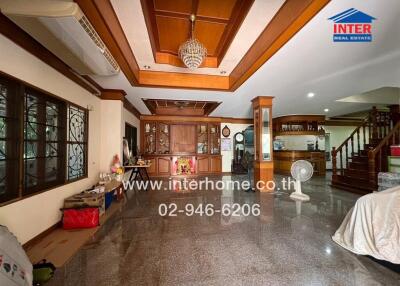 Spacious main living area with wooden ceiling details and granite flooring
