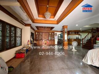 Spacious main living area with wooden ceiling details and granite flooring