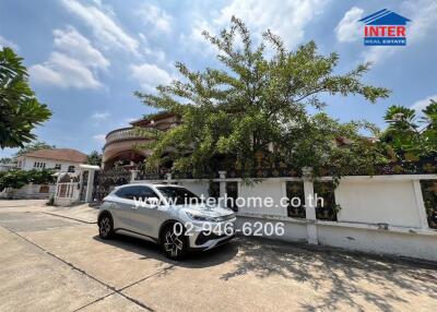 Photo of a residential building with a car parked in front