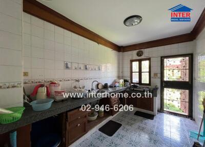 Traditional kitchen with tiled walls and countertops