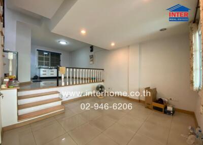 Spacious living room with balcony view and tiled flooring