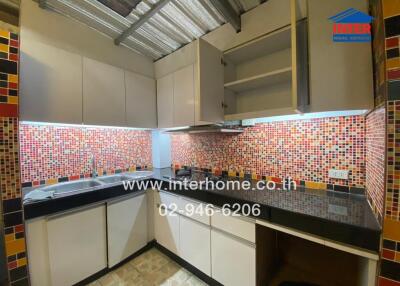 Modern kitchen with colorful mosaic tile backsplash.