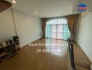 Spacious main living area with wooden flooring and large windows