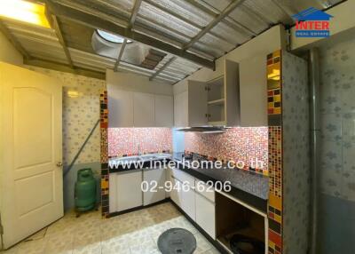 Modern kitchen with tiled backsplash and cabinets