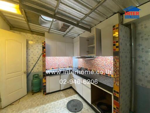 Modern kitchen with tiled backsplash and cabinets