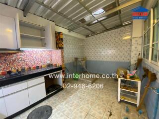 Kitchen with shelves, tiled backsplash, and open storage