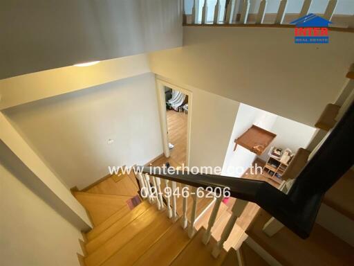 Staircase leading to multiple floors with wooden steps